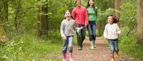 Family walking in the woods. homes for sale south lanarkshire, houses to buy east kilbride, new build homes