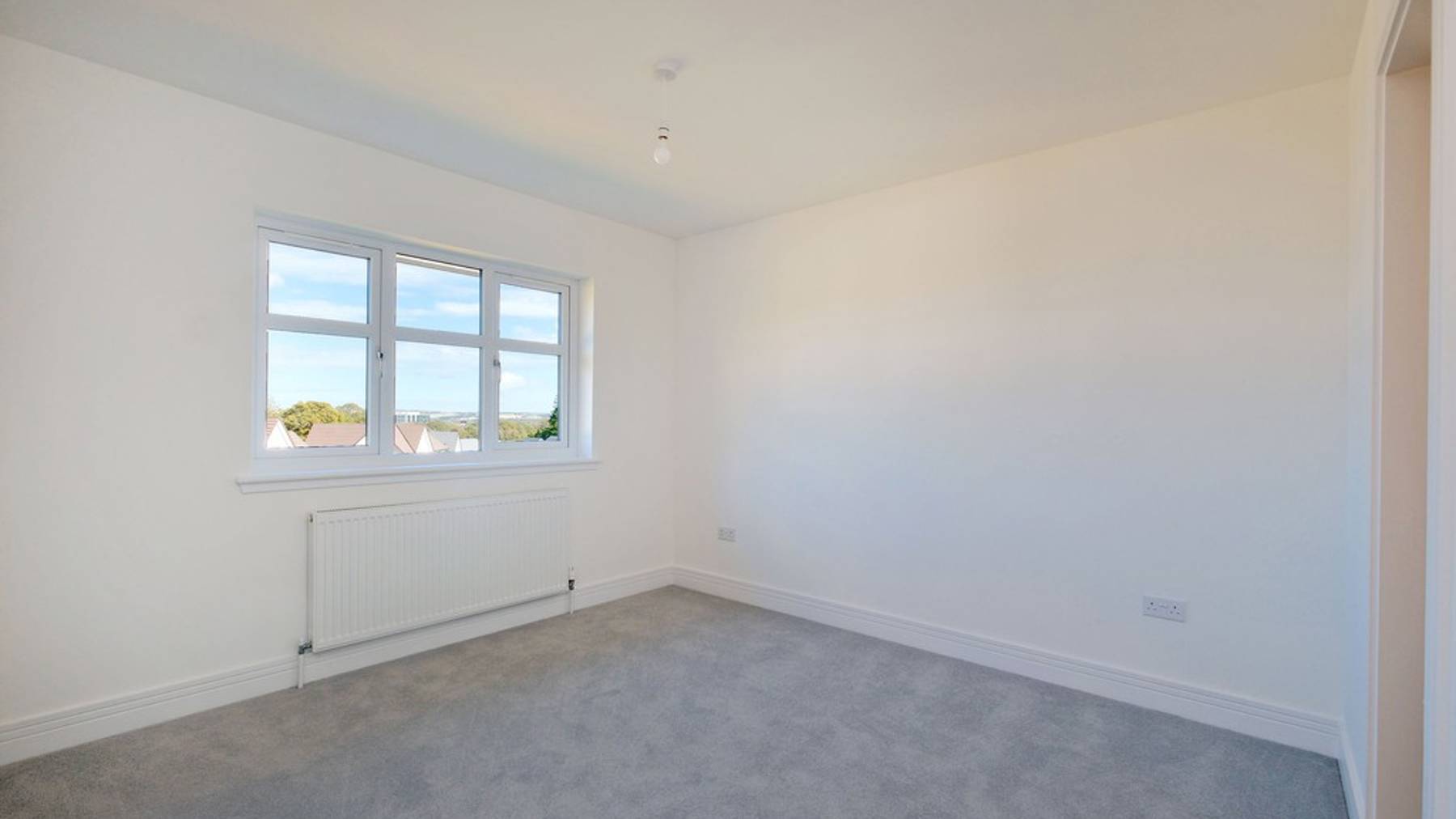 Spacious and bright bedroom with large window 