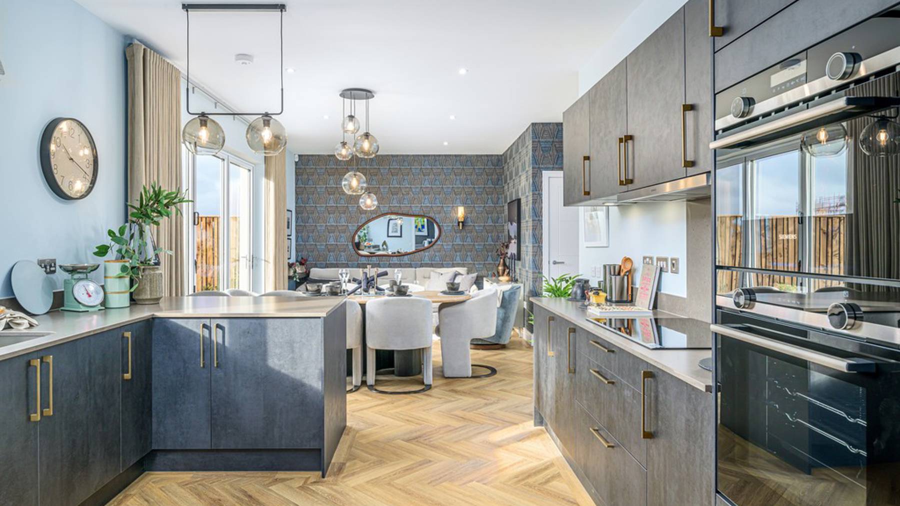 5 bedroom showhome | open plan studio-style kitchen, dining and family area with bi-fold doors to garden