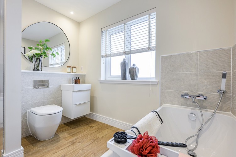 4 bedroom showhome | stylish family bathroom with sleek fittings and half-height tiling